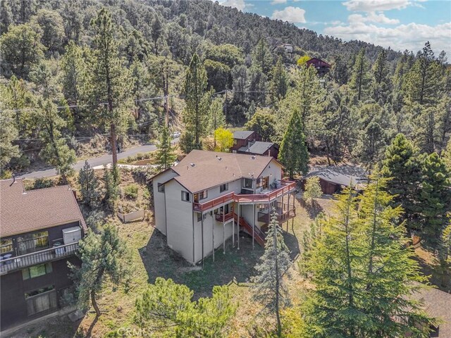 drone / aerial view featuring a forest view