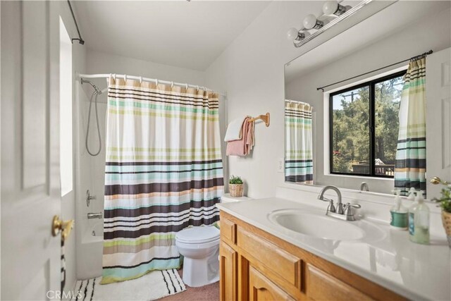 full bath featuring toilet, shower / bathtub combination with curtain, and vanity