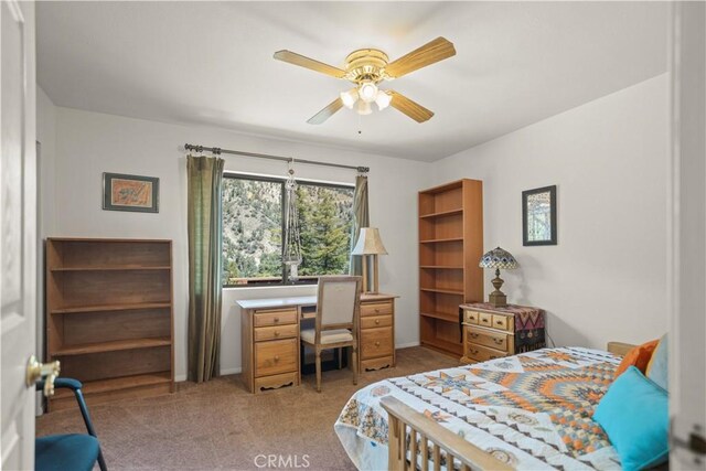 bedroom featuring baseboards, ceiling fan, and light colored carpet