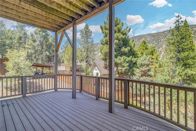 wooden deck featuring a mountain view