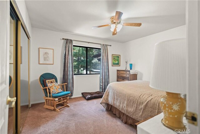 carpeted bedroom with baseboards, ceiling fan, and a closet
