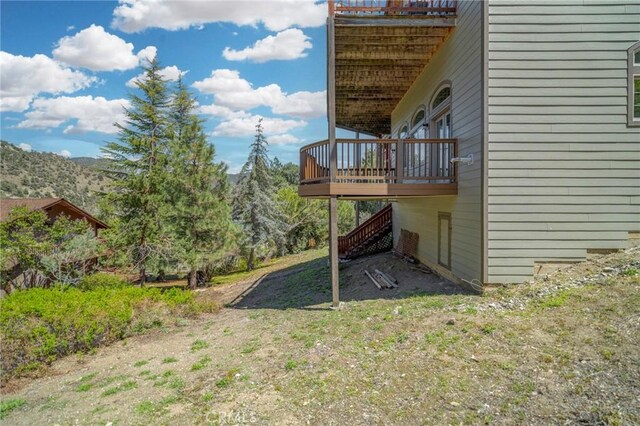 view of yard featuring a wooden deck and stairway