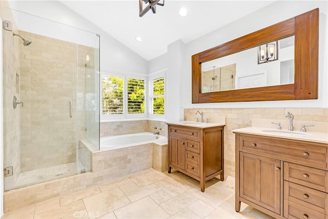 full bath with vaulted ceiling, a sink, and a stall shower