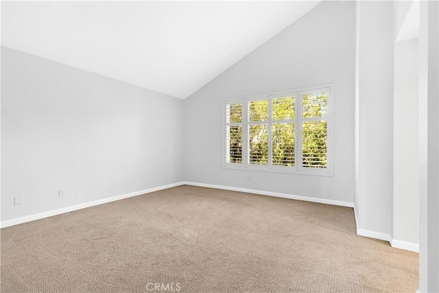 unfurnished room with baseboards, carpet, and high vaulted ceiling