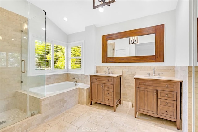 bathroom with vanity, tile patterned floors, a shower stall, vaulted ceiling, and a garden tub