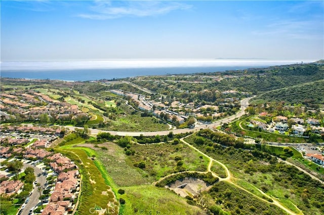 drone / aerial view featuring a water view and a residential view