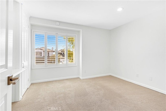 unfurnished room with baseboards, light carpet, and recessed lighting