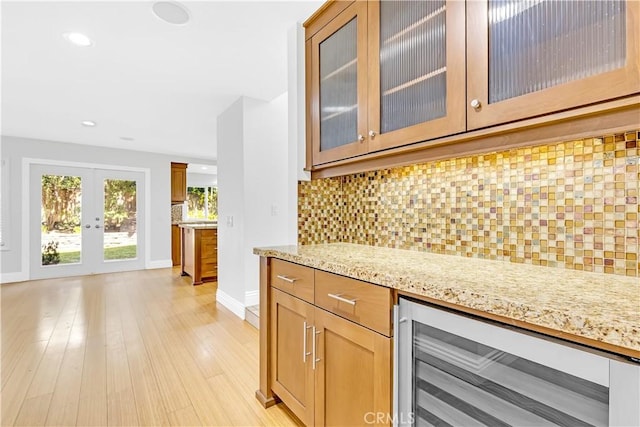 bar featuring beverage cooler, french doors, recessed lighting, baseboards, and tasteful backsplash