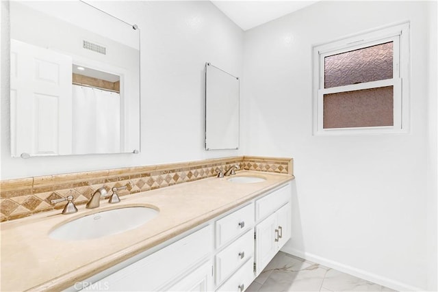 bathroom featuring visible vents, a sink, marble finish floor, and double vanity
