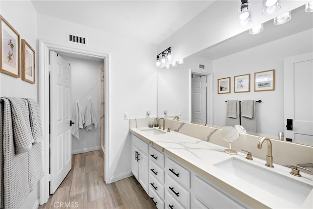 14 Belaire, Laguna Niguel, CA 92677 - bathroom with a sink, double vanity, wood finished floors, and visible vents