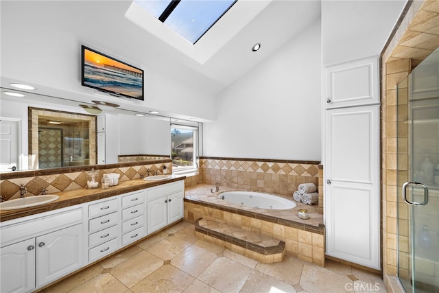14 Belaire, Laguna Niguel, CA 92677 - bathroom with double vanity, a sink, high vaulted ceiling, and a skylight