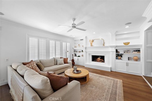 14 Belaire, Laguna Niguel, CA 92677 - living area with crown molding, wood finished floors, ceiling fan, a warm lit fireplace, and built in shelves