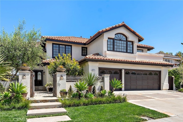 14 Belaire, Laguna Niguel, CA 92677 - mediterranean / spanish house featuring concrete driveway, a tiled roof, an attached garage, and stucco siding