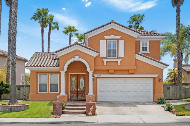 view of front of house featuring stucco siding, fence, driveway, and a tile roof