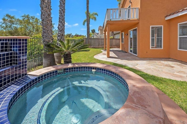 view of swimming pool featuring an in ground hot tub, fence, and a patio area
