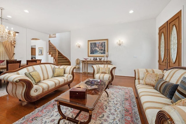 living room with stairway, recessed lighting, wood finished floors, and a chandelier