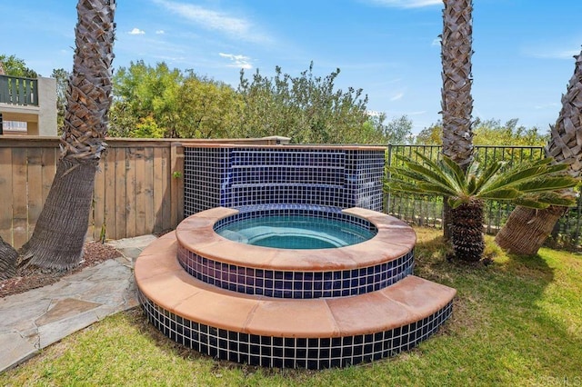 exterior details featuring a jacuzzi and fence