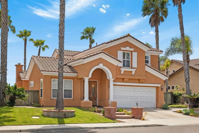 mediterranean / spanish-style home with fence, stucco siding, driveway, and a garage