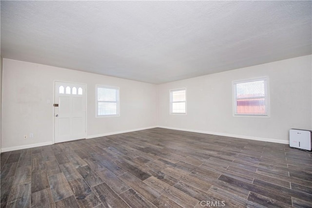 945 10th St, Huntington Beach, CA 92648 - interior space featuring baseboards, a textured ceiling, and dark wood-style flooring