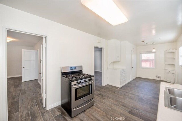 945 10th St, Huntington Beach, CA 92648 - kitchen with light countertops, stainless steel gas range, white cabinets, and dark wood-type flooring
