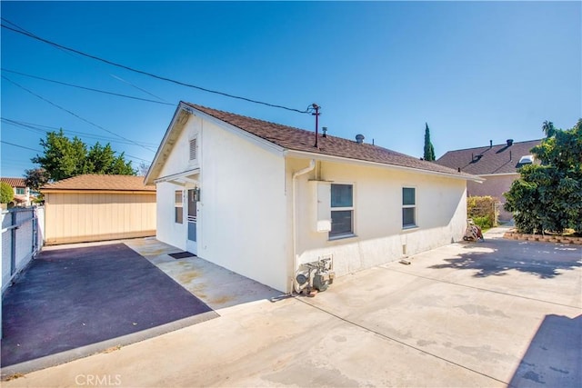 945 10th St, Huntington Beach, CA 92648 - view of property exterior featuring a fenced backyard, stucco siding, and a patio area