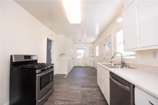 945 10th St, Huntington Beach, CA 92648 - kitchen with white cabinets, appliances with stainless steel finishes, a sink, and light countertops
