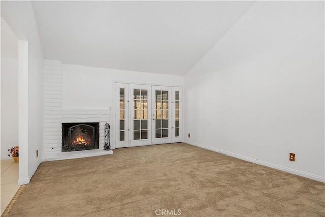 unfurnished living room with a fireplace, baseboards, and carpet