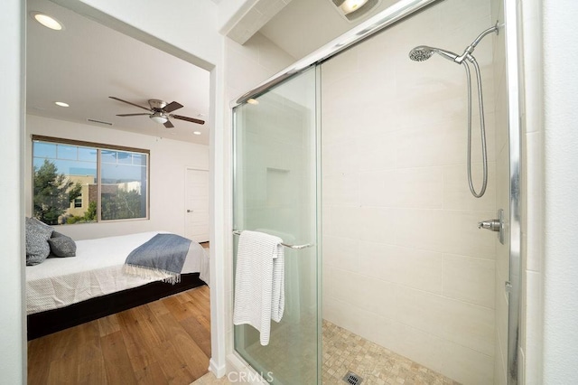 full bathroom with connected bathroom, ceiling fan, wood finished floors, and a stall shower