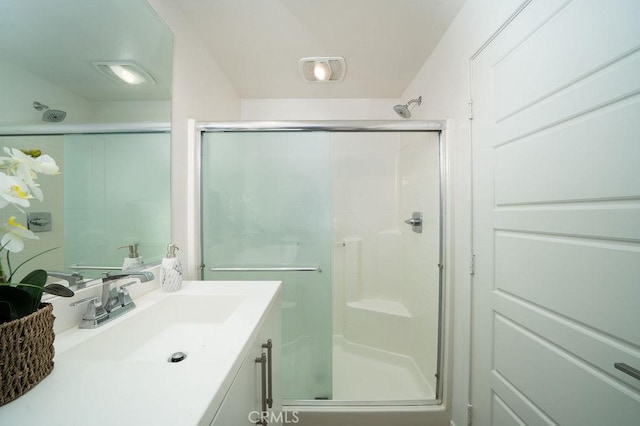 bathroom featuring a shower stall and vanity