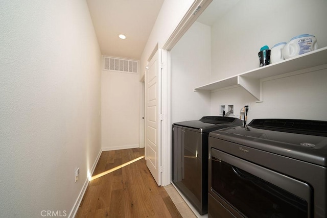 washroom featuring laundry area, visible vents, light wood finished floors, recessed lighting, and washer and clothes dryer