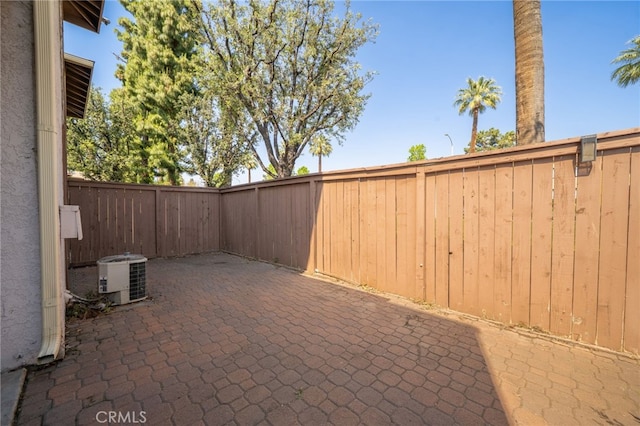 view of patio with a fenced backyard and central AC