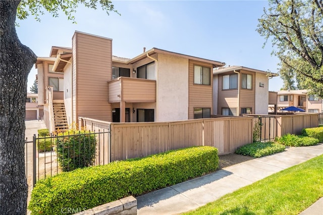 exterior space featuring fence private yard and stucco siding