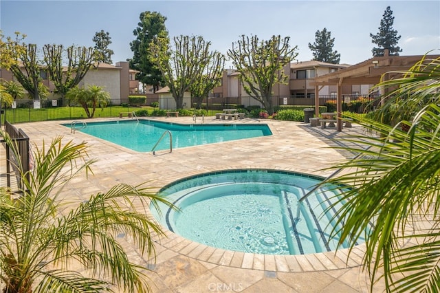 1303 Massachusetts Ave Unit 101, Riverside, CA 92507 - community pool featuring a patio, a hot tub, fence, and a residential view