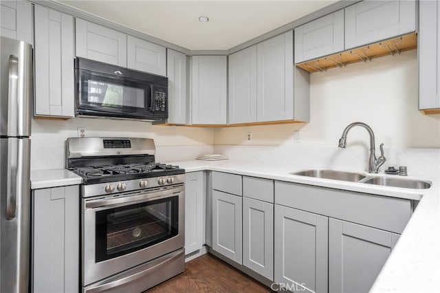 kitchen featuring a sink, gray cabinets, appliances with stainless steel finishes, and light countertops