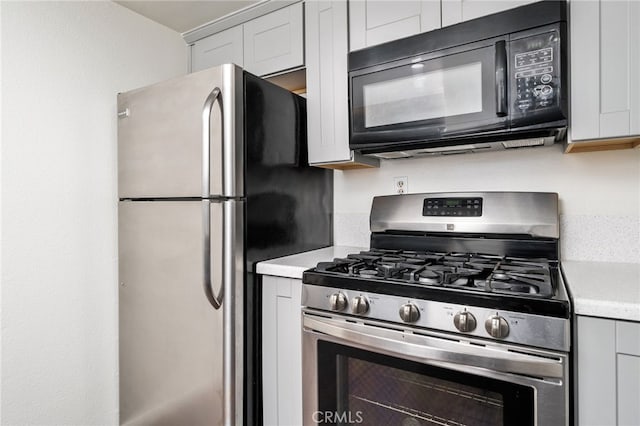kitchen with light countertops, white cabinetry, and appliances with stainless steel finishes