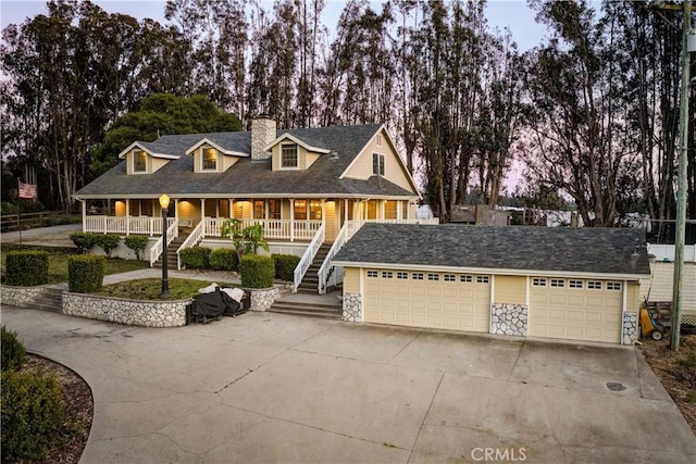 1473 Willow Rd, Nipomo, CA 93444 - view of front of home with stairs, a porch, a garage, a chimney, and concrete driveway