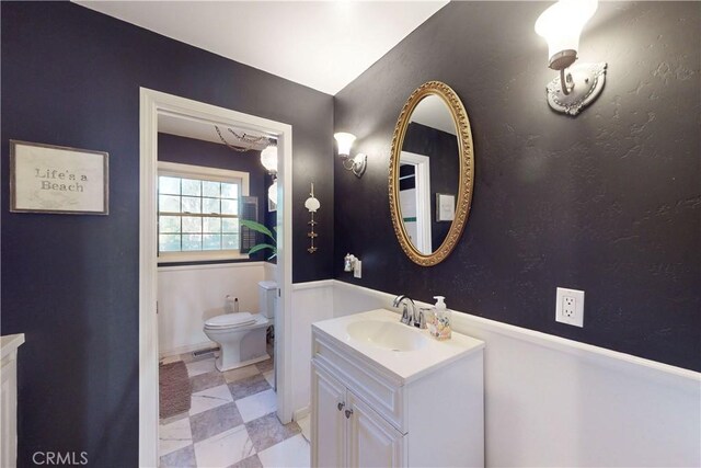bathroom with toilet and vanity