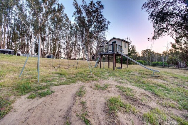 view of yard featuring fence and playground community