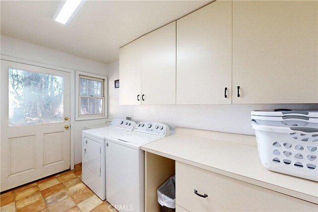 laundry area featuring washer and clothes dryer and cabinet space