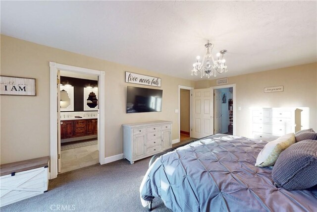 bedroom featuring carpet flooring, baseboards, an inviting chandelier, and ensuite bath