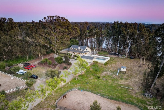 aerial view at dusk with a view of trees