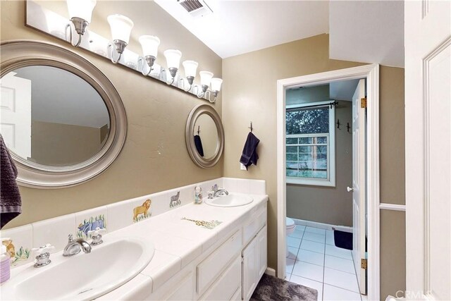 full bath with toilet, tile patterned floors, visible vents, and a sink