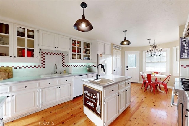 1473 Willow Rd, Nipomo, CA 93444 - kitchen featuring dishwasher, a chandelier, backsplash, and light wood-type flooring