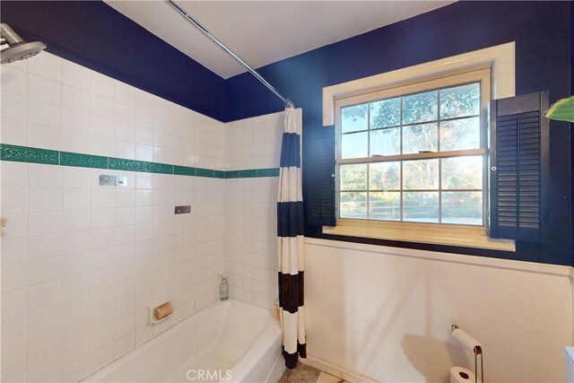 full bath featuring shower / bath combo with shower curtain