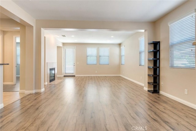 26121 Citron St, Loma Linda, CA 92354 - unfurnished living room with baseboards, wood finished floors, and a fireplace
