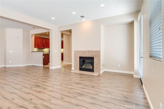 26121 Citron St, Loma Linda, CA 92354 - unfurnished living room with visible vents, a fireplace, baseboards, recessed lighting, and light wood-style flooring