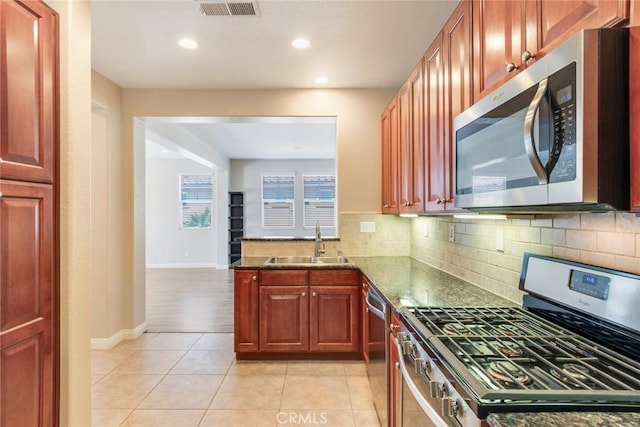 26121 Citron St, Loma Linda, CA 92354 - kitchen with visible vents, a sink, decorative backsplash, and appliances with stainless steel finishes