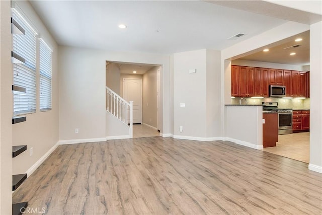 26121 Citron St, Loma Linda, CA 92354 - unfurnished living room featuring visible vents, light wood-style flooring, and stairs