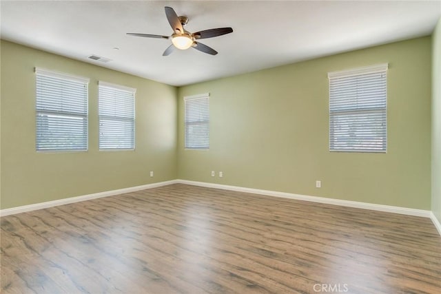 26121 Citron St, Loma Linda, CA 92354 - empty room featuring visible vents, a ceiling fan, baseboards, and wood finished floors