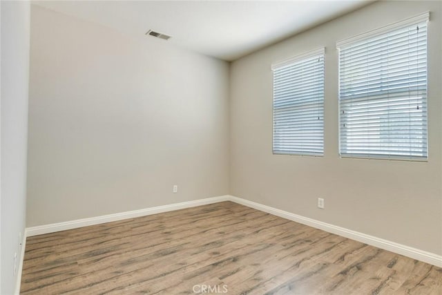 26121 Citron St, Loma Linda, CA 92354 - spare room featuring baseboards, visible vents, and wood finished floors